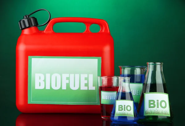 Bio fuels in canister and vials on green background — Stock Photo, Image