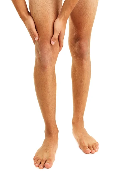 Hombre joven con dolor de rodilla, aislado en blanco — Foto de Stock