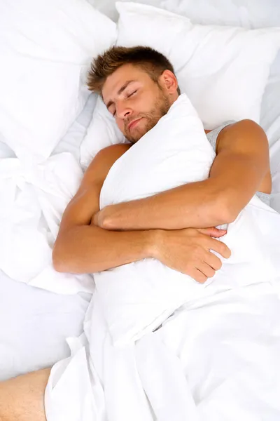 Handsome young man in bed — Stock Photo, Image