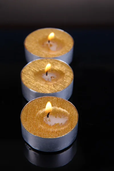 Golden candles isolated on black — Stock Photo, Image