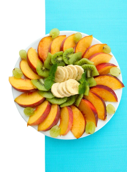 Assortment of sliced fruits on plate, isolated on white — Stock Photo, Image