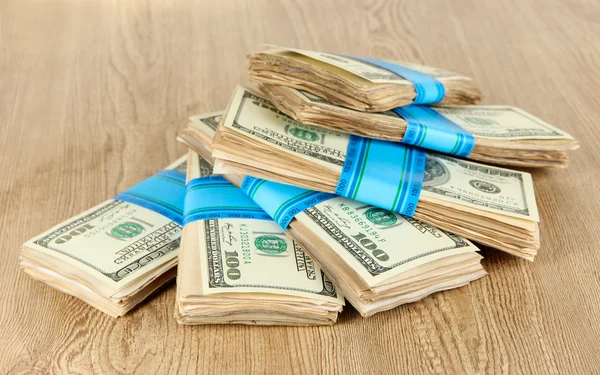 Stacks of money on wooden table — Stock Photo, Image