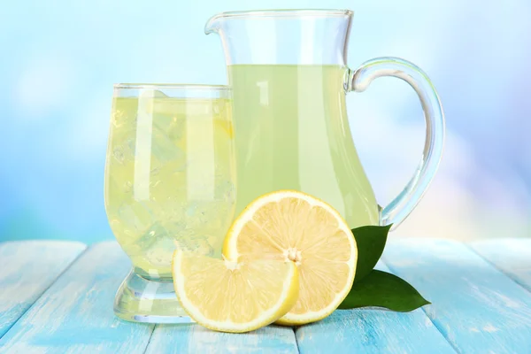 Delicious lemonade on table on blue background — Stock Photo, Image