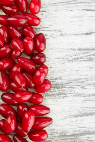 Fresh cornel berries on wooden background — Stock Photo, Image