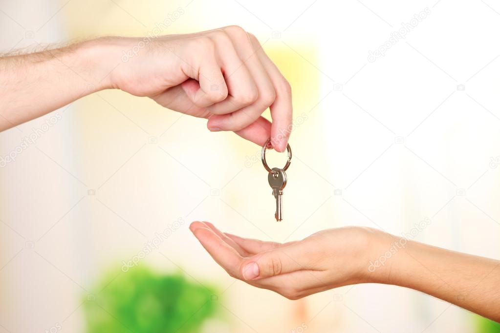 Transfer of house key, on bright background