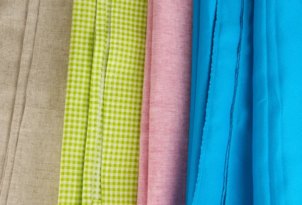 Pile of different fabrics close-up background — Stock Photo, Image