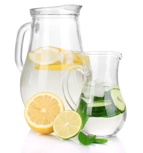 Cold water with lemon, cucumber and ice in pitchers isolated on white — Stock Photo, Image