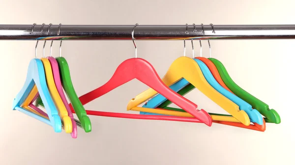 Colorful clothes hangers on gray background — Stock Photo, Image