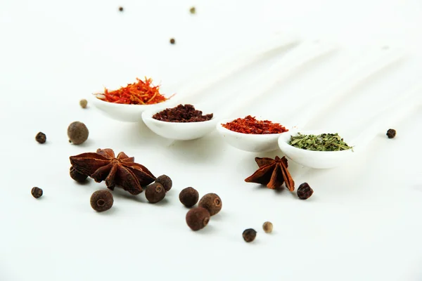 Assortment of spices in white spoons, isolated on white — Stock Photo, Image