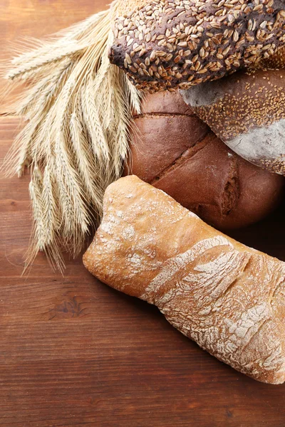 Much bread on wooden board — Stock Photo, Image