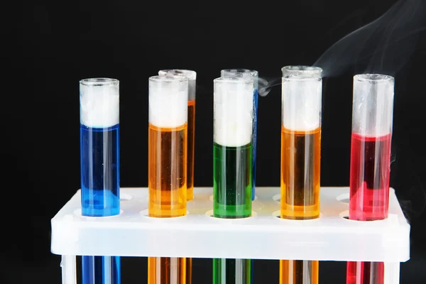Laboratory test tubes on black background — Stock Photo, Image