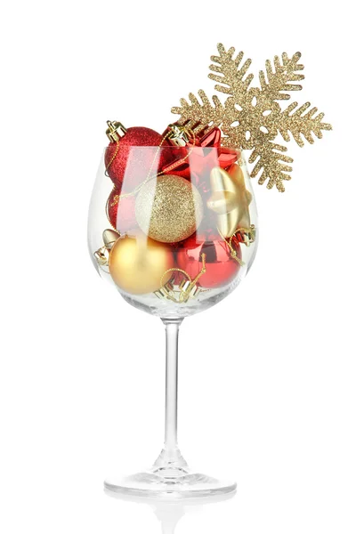 Wine glass filled with christmas decorations, isolated on white — Stock Photo, Image