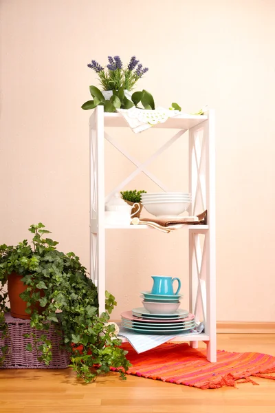 Красиві білі полки з посудом і декором, на кольоровому тлі стін — стокове фото