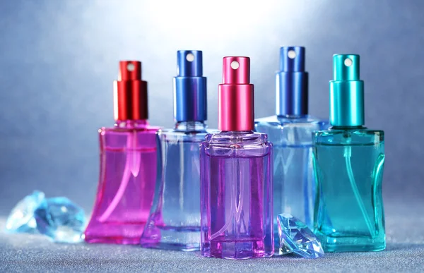 Donne profumo in belle bottiglie su sfondo luminoso — Foto Stock