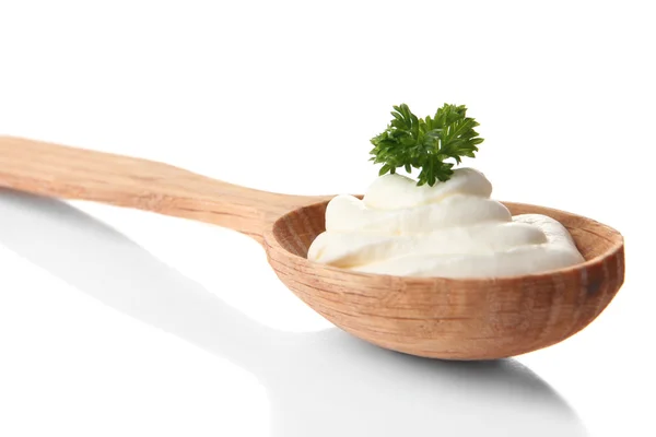 Sour cream in spoon isolated on white — Stock Photo, Image