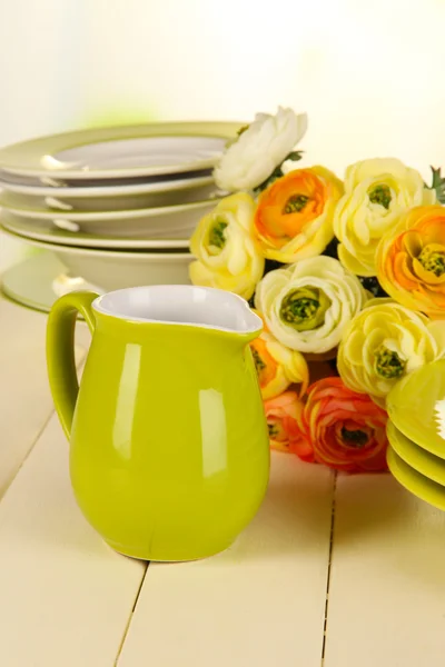 Lots beautiful dishes on wooden table on bright background — Stock Photo, Image