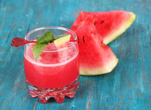 Glass of fresh watermelon juice, on wooden table, on wooden background — Stock Photo, Image