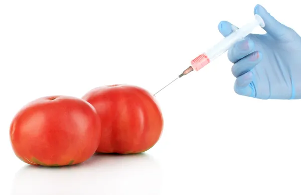 Injection dans une tomate rouge fraîche isolée sur du blanc — Photo