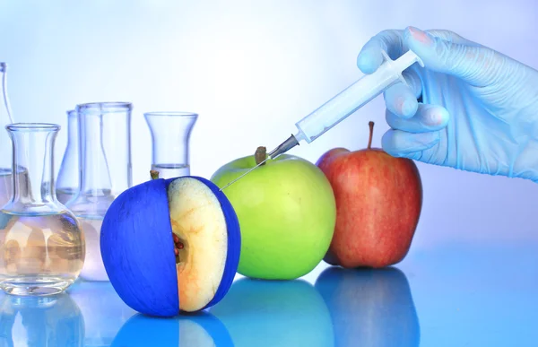 Injection into apple on blue background — Stock Photo, Image