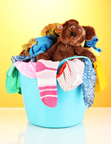 Blue laundry basket on orange background — Stock Photo, Image
