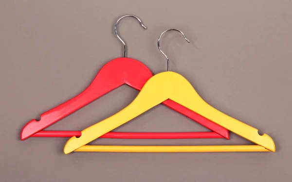 Colorful clothes hangers on gray background — Stock Photo, Image