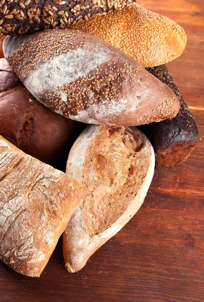 Much bread on wooden board — Stock Photo, Image