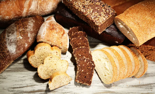 Much bread on wooden board — Stock Photo, Image