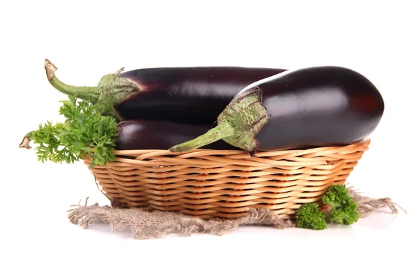 Fresh eggplants in wicker basket isolated on white — Stock Photo, Image