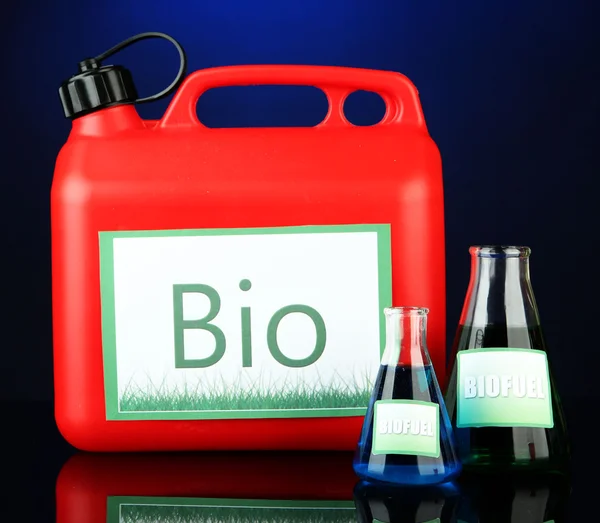 Bio fuels in canister and vials on blue background — Stock Photo, Image