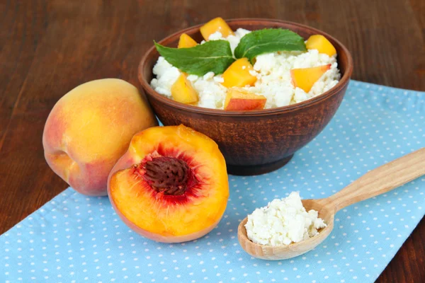 Sour cheese and fresh peaches,on wooden table background — Stock Photo, Image