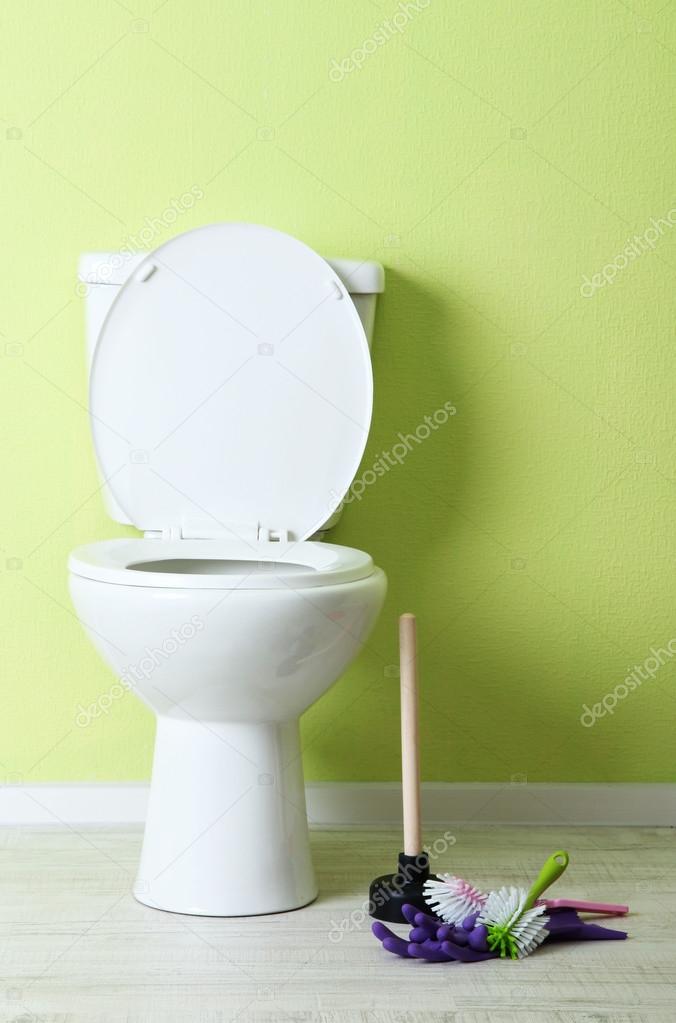 White toilet bowl and cleaner things in a bathroom