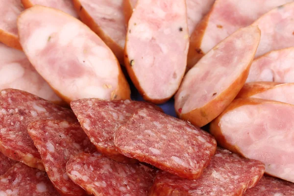 Tasty sliced sausage on plate close-up — Stock Photo, Image