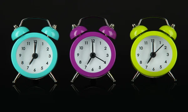 Colorful alarm clock on dark grey background — Stock Photo, Image