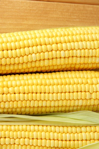 Crude corns on wooden table — Stock Photo, Image