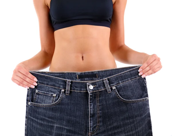 Menina magro com jeans grandes isolado no branco — Fotografia de Stock