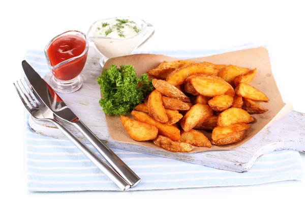 Home potatoes on tracing paper on wooden board isolated on white — Stock Photo, Image