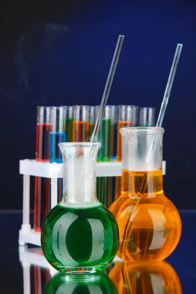Laboratory glassware on dark color background — Stock Photo, Image