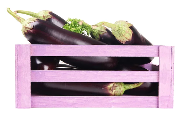 Fresh eggplants in wooden box isolated on white — Stockfoto
