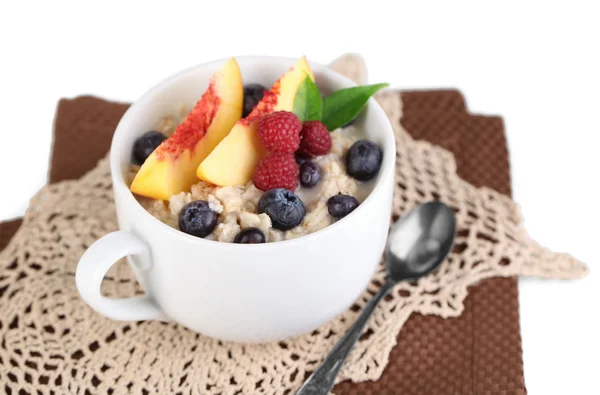 Oatmeal in cup with berries on napkins isolated on white — Stock Photo, Image