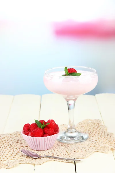 Raspberry milk dessert in cocktail glass, on light background — Stock Photo, Image