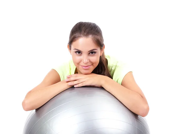 Young beautiful fitness girl with grey ball isolated on white — Stock Photo, Image