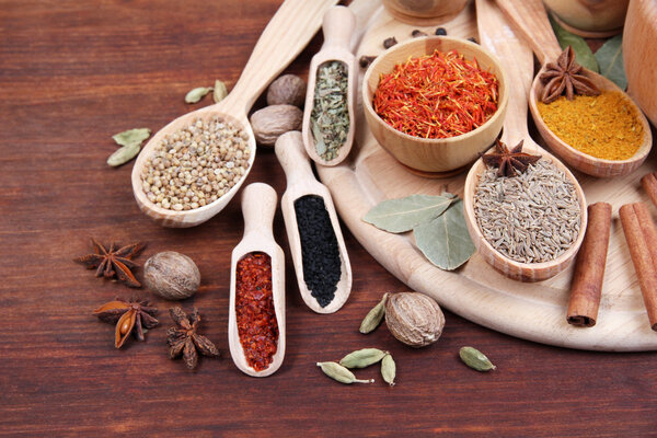 Various spices and herbs on wooden table