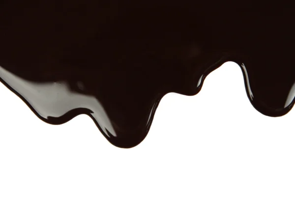 Melted chocolate dripping on white background — Stock Photo, Image