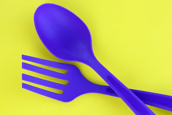 Utensílios de cozinha de plástico no fundo amarelo — Fotografia de Stock