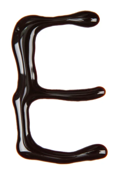 チョコレート シロップ、白で隔離されるから作られたアルファベットの文字 — ストック写真