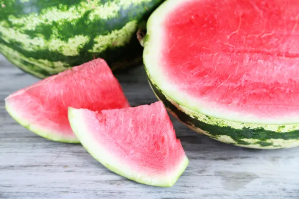 Ripe watermelons on wooden table — Stock Photo, Image