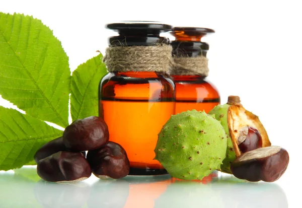 Medicine bottles with chestnuts and leaves, isolated on white — Stock Photo, Image