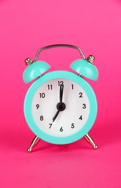 Blue alarm clock on pink background — Stock Photo, Image