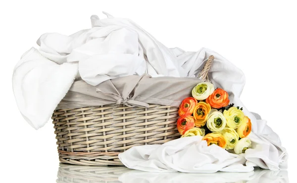 Rumpled bedding sheets in wicker basket isolated on white — Stock Photo, Image