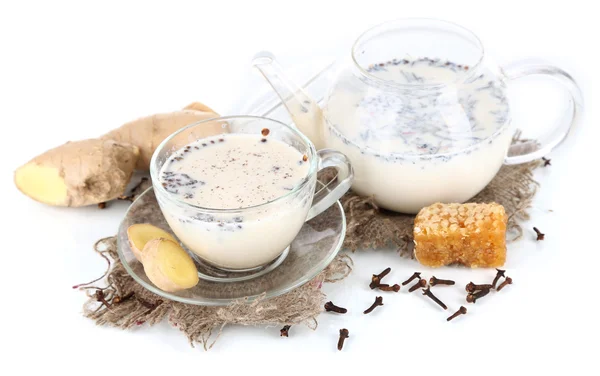 Teapot and cup of tea with milk and spices on sackcloth isolated on white — Stock Photo, Image